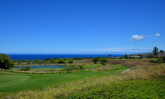 view of property's community with golf course view and a water view