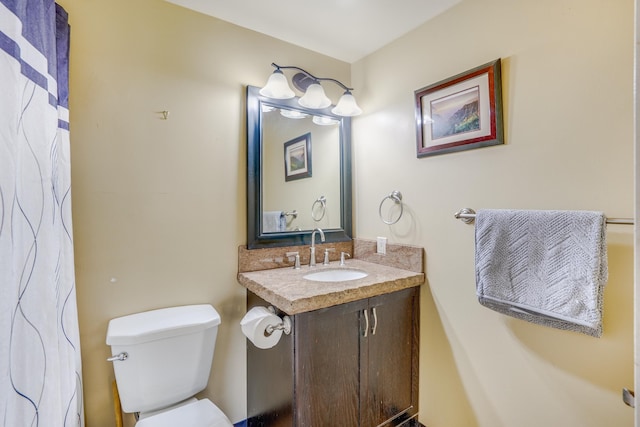 bathroom featuring toilet and vanity