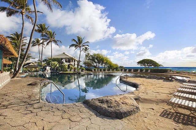 view of swimming pool with a water view