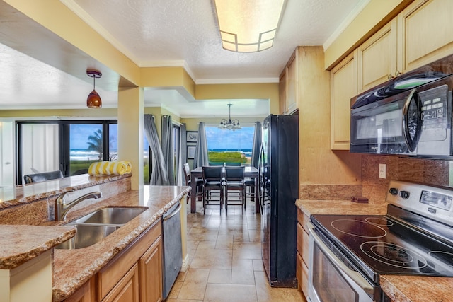 kitchen featuring pendant lighting, a textured ceiling, stainless steel appliances, and a sink