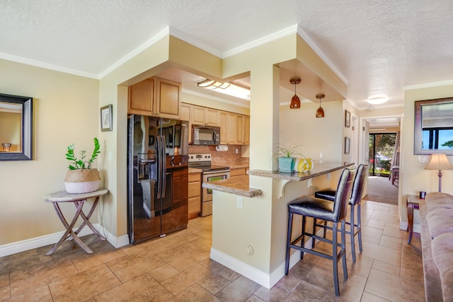 kitchen with black appliances, light brown cabinetry, backsplash, a peninsula, and a breakfast bar area