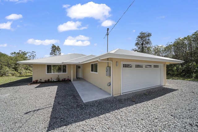 ranch-style house featuring an attached garage and driveway