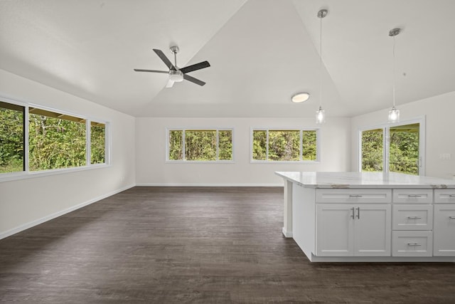 kitchen with dark wood-style floors, decorative light fixtures, lofted ceiling, open floor plan, and white cabinetry