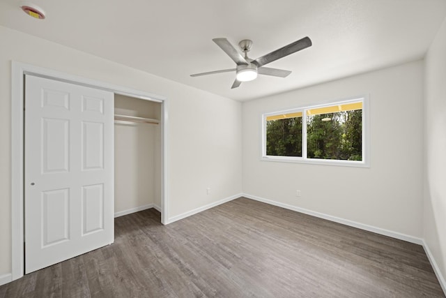 unfurnished bedroom with a ceiling fan, a closet, baseboards, and wood finished floors