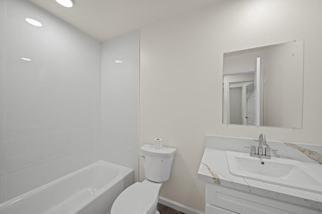 full bath with  shower combination, baseboards, vanity, and toilet