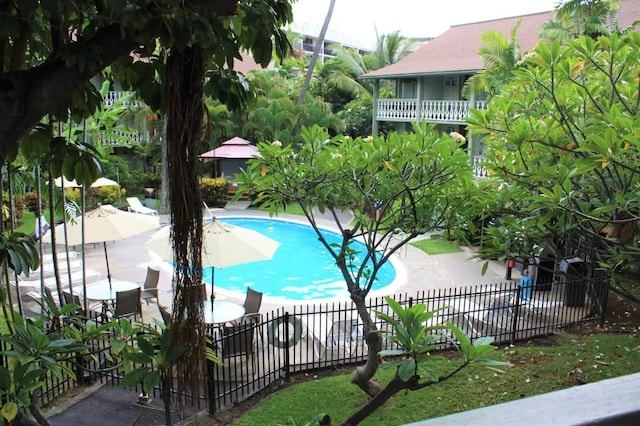 view of swimming pool featuring a patio area, a fenced in pool, and fence