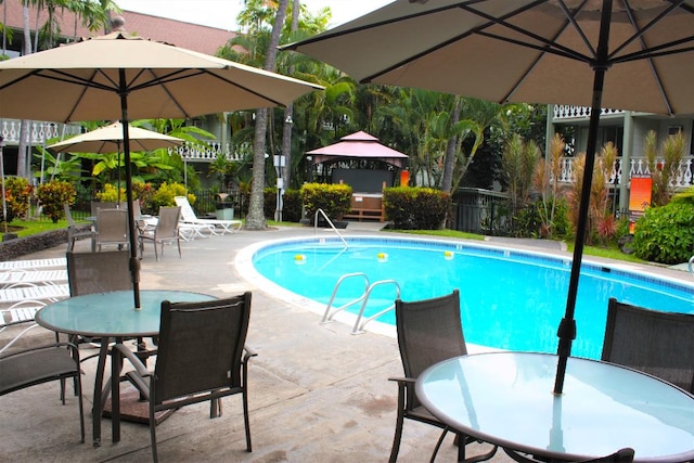 view of pool with a fenced in pool, a patio, outdoor dining space, and fence