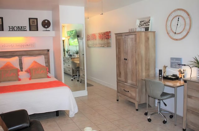 bedroom featuring light tile patterned flooring and baseboards