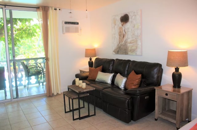 living area featuring light tile patterned floors and a wall unit AC