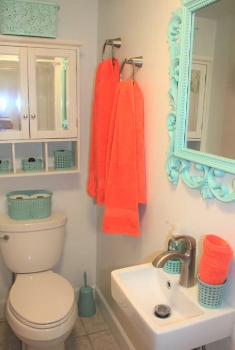 half bathroom with a sink, baseboards, toilet, and tile patterned floors