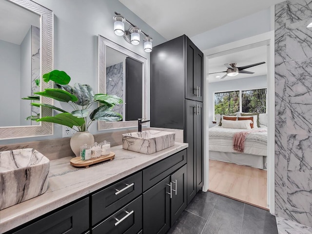 full bathroom featuring a ceiling fan, vanity, and ensuite bath