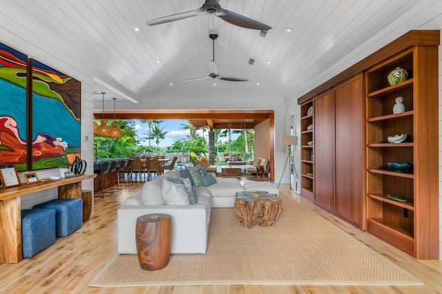 living area with built in shelves, wood ceiling, vaulted ceiling, and light wood finished floors