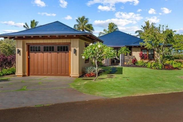 view of outdoor structure with a garage, an outdoor structure, and driveway