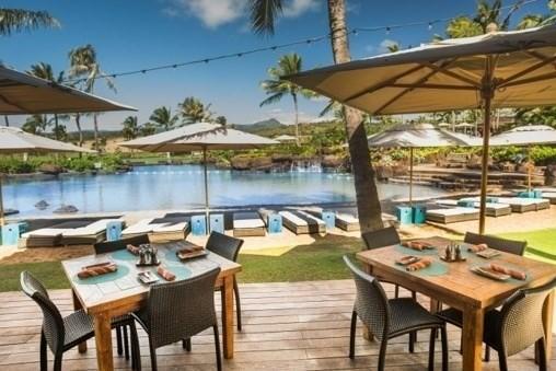 wooden deck featuring a water view, a dock, and outdoor dining space