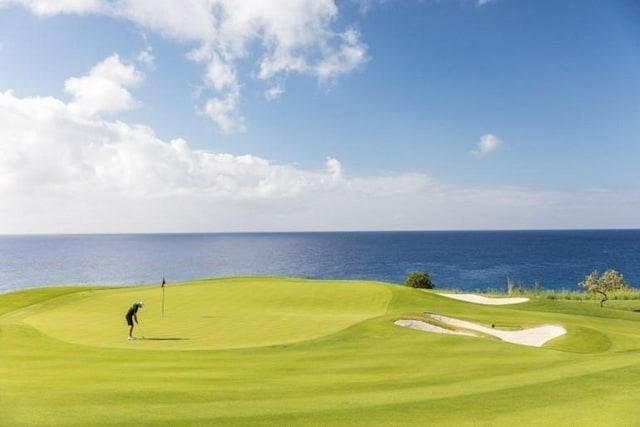 view of home's community with view of golf course and a water view