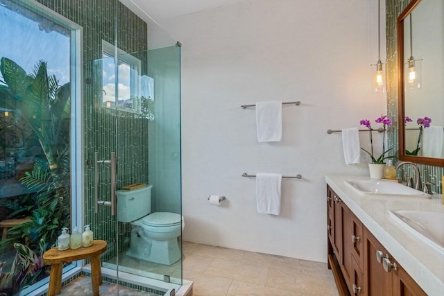 full bathroom featuring double vanity, tile patterned flooring, a sink, and toilet