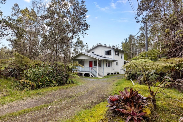 view of front of house with driveway and a porch