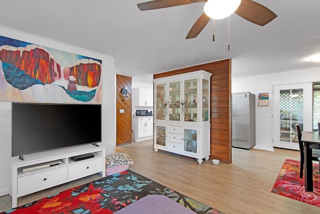 living room with wood finished floors and ceiling fan