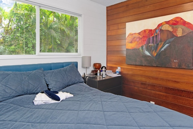 bedroom featuring wood walls