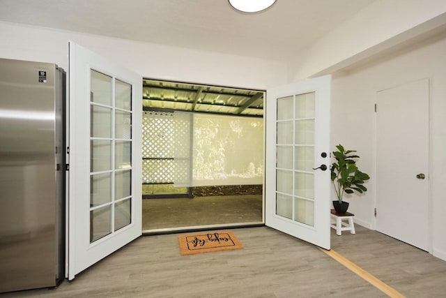 doorway to outside featuring french doors and wood finished floors