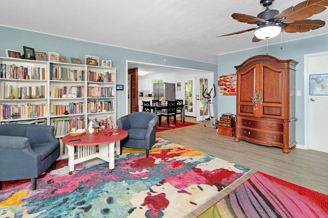 living area featuring ceiling fan, french doors, and wood finished floors