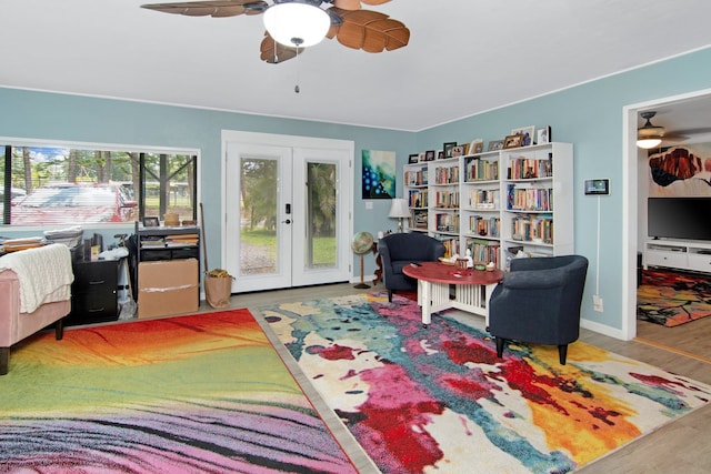 bedroom featuring wood finished floors, baseboards, ceiling fan, french doors, and access to outside