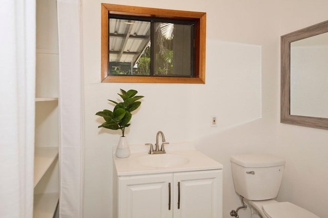 half bathroom featuring toilet and vanity