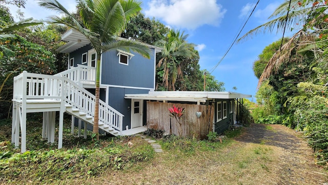 view of side of home featuring stairway