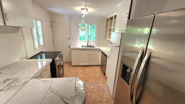 kitchen featuring stainless steel appliances, ornamental molding, a sink, and a wealth of natural light