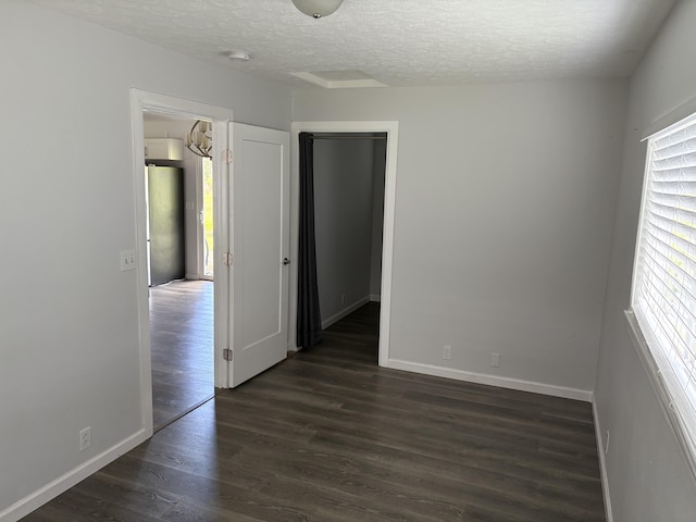 15-1509 22nd Ave, Keaau, HI 96749 - unfurnished room with a textured ceiling, dark wood finished floors, and baseboards