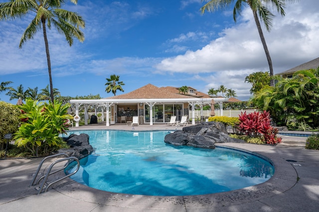 pool featuring a patio area, fence, and a pergola