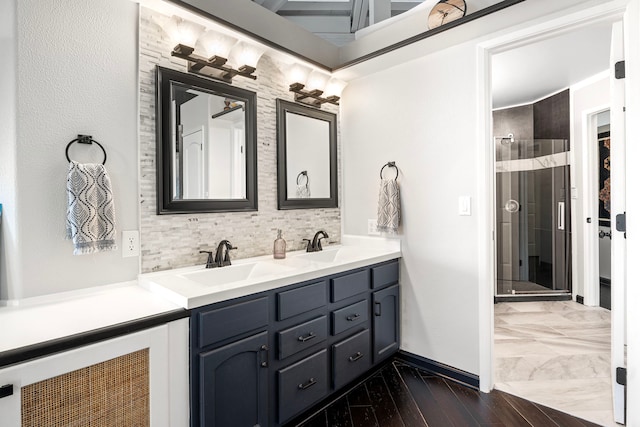 bathroom with double vanity, tasteful backsplash, a shower, and a sink