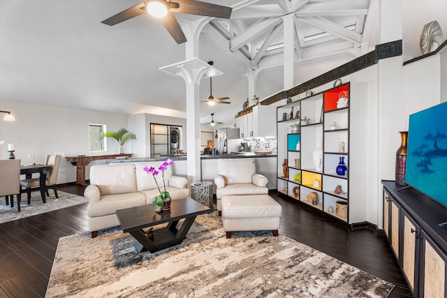 living room featuring a ceiling fan, baseboards, beamed ceiling, dark wood-style floors, and coffered ceiling