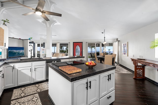 kitchen with white cabinetry, ceiling fan, lofted ceiling, and dark countertops