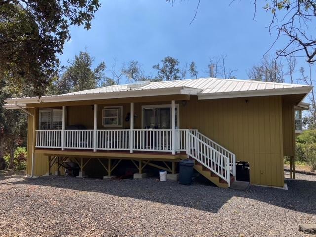 view of front of property with covered porch and metal roof