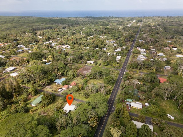 bird's eye view with a wooded view