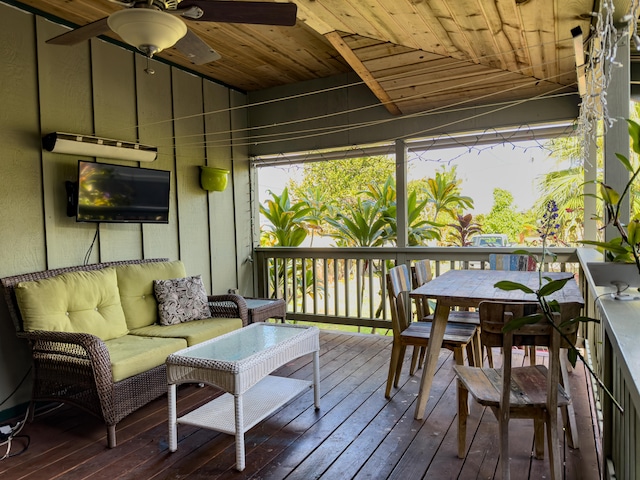 wooden terrace with ceiling fan and an outdoor hangout area