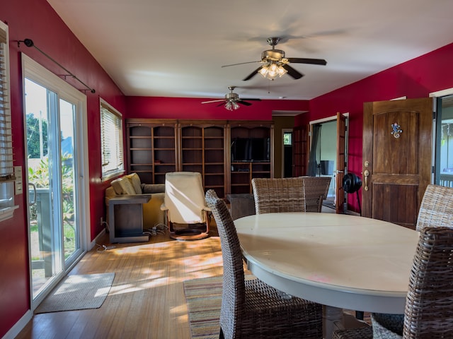 dining space with ceiling fan, plenty of natural light, and wood-type flooring