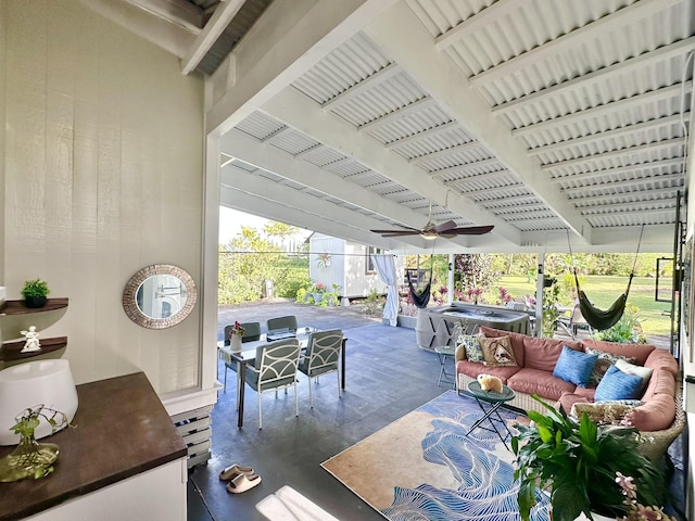 view of patio / terrace with an outdoor living space, a hot tub, and a ceiling fan