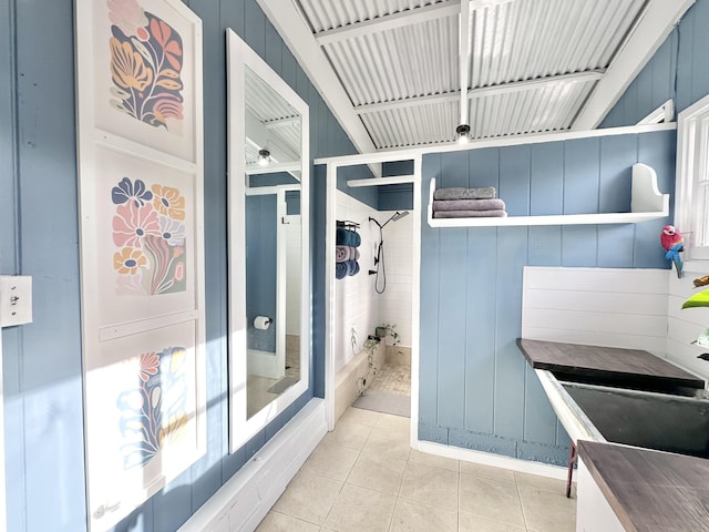 bathroom with tile patterned floors and a shower stall