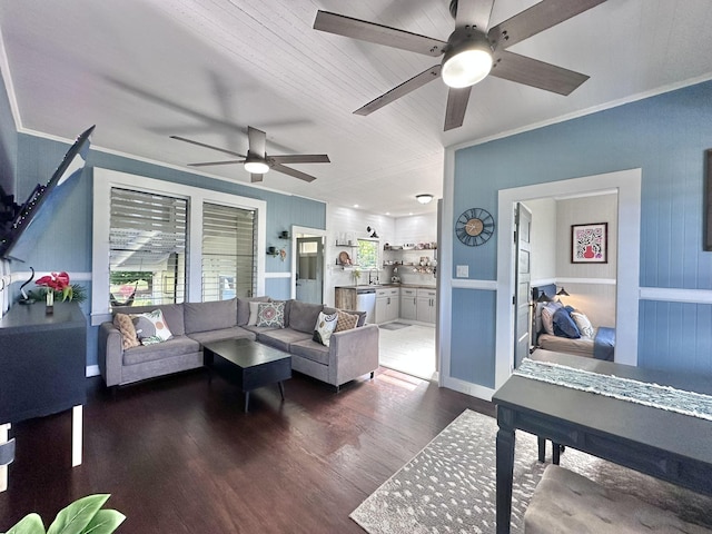 living room with crown molding and wood finished floors