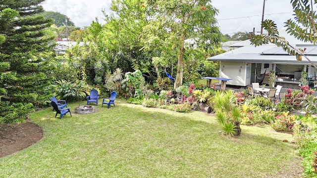 view of yard featuring a patio and an outdoor fire pit