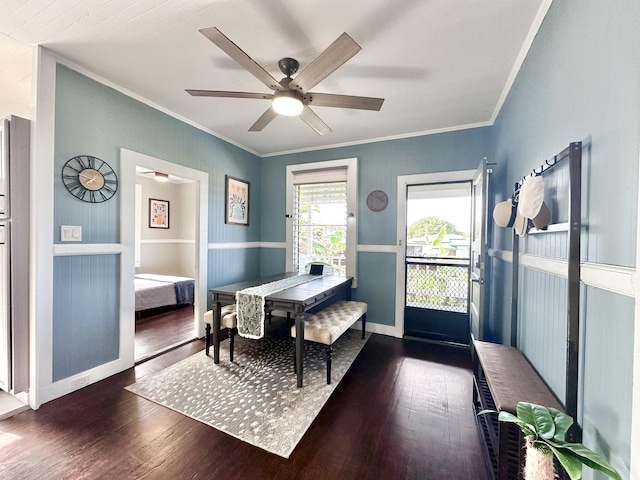 dining space featuring crown molding, dark wood-style floors, baseboards, and ceiling fan