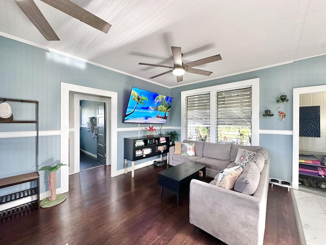 living room with baseboards, crown molding, ceiling fan, and wood finished floors