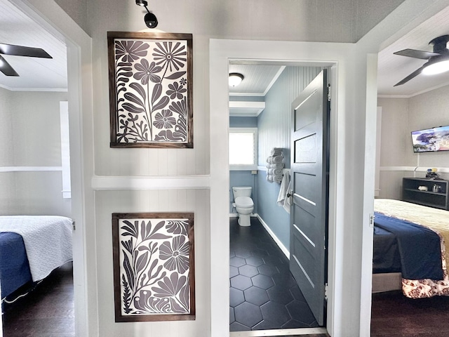 interior space with crown molding, a ceiling fan, and connected bathroom