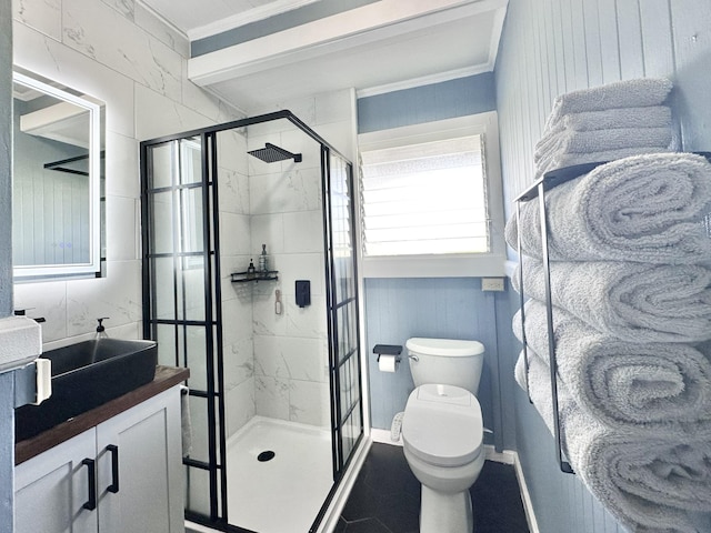 bathroom featuring toilet, a stall shower, vanity, and ornamental molding