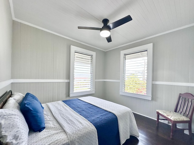 bedroom with ceiling fan, wood finished floors, and ornamental molding