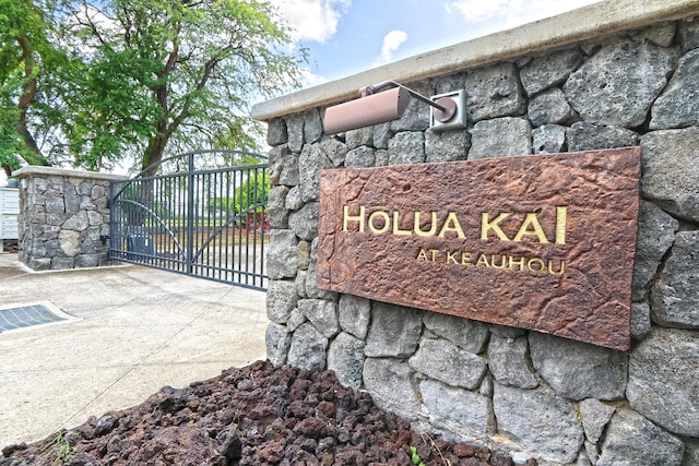 community sign with a gate and fence