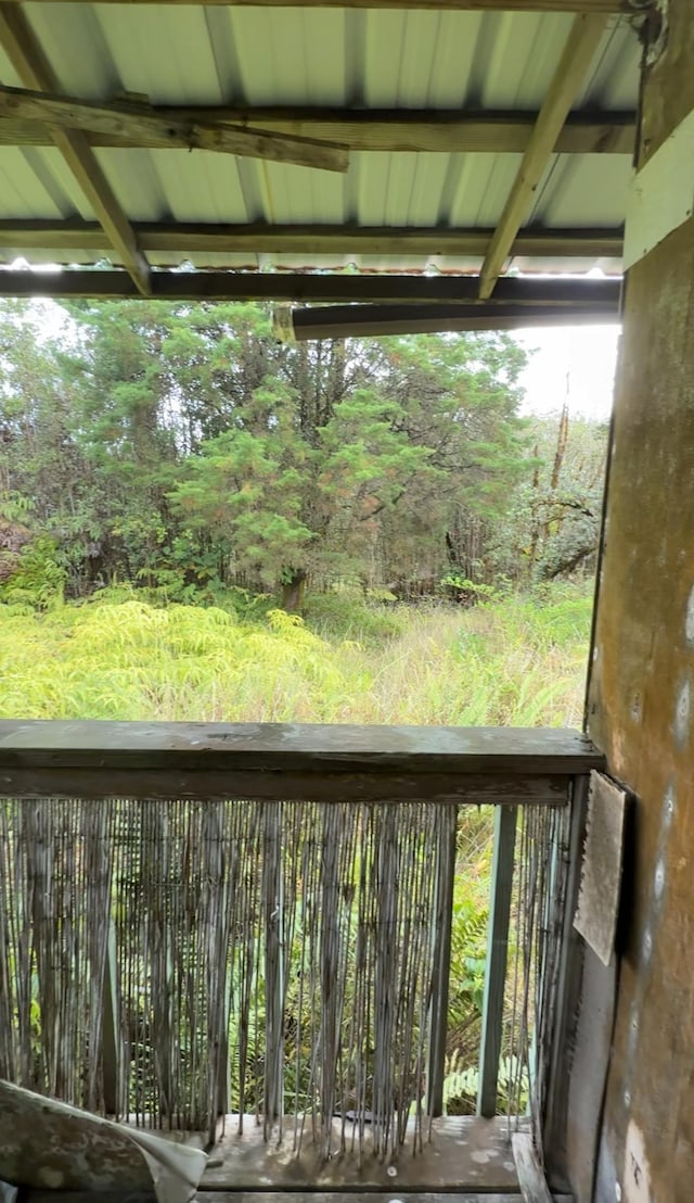 balcony featuring a forest view
