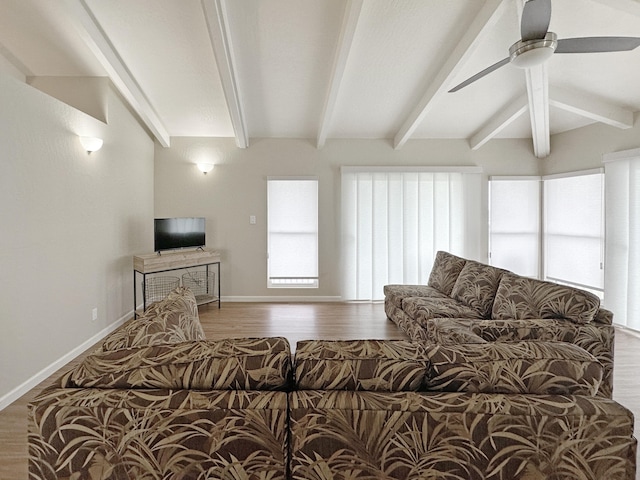 living room featuring beamed ceiling, wood finished floors, and baseboards